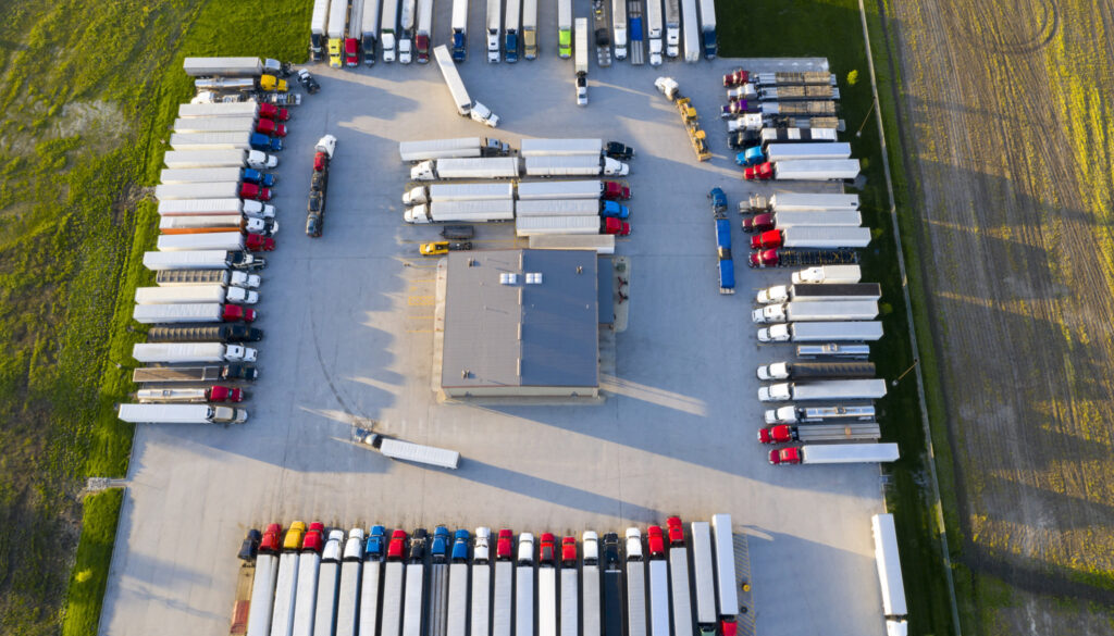 Large Group of Semi Trucks at Truck Stop, Aerial View